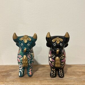 Two floral painted ceramic bulls